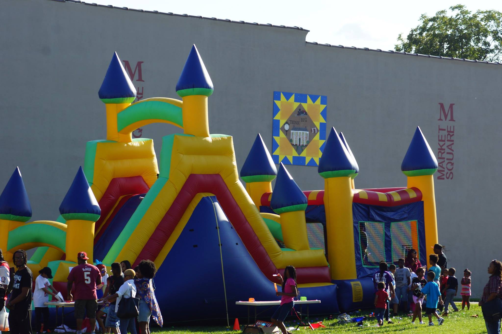 Families enjoying a large inflatable play area