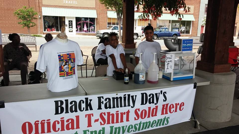 Young people serving refreshments at an event booth